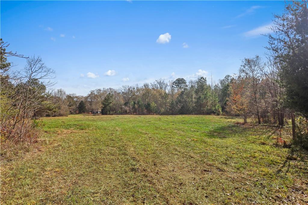 63 Paul Smith Road Covington, GA 30014 - Photo 7 of 13 a view of a field with trees in the background
