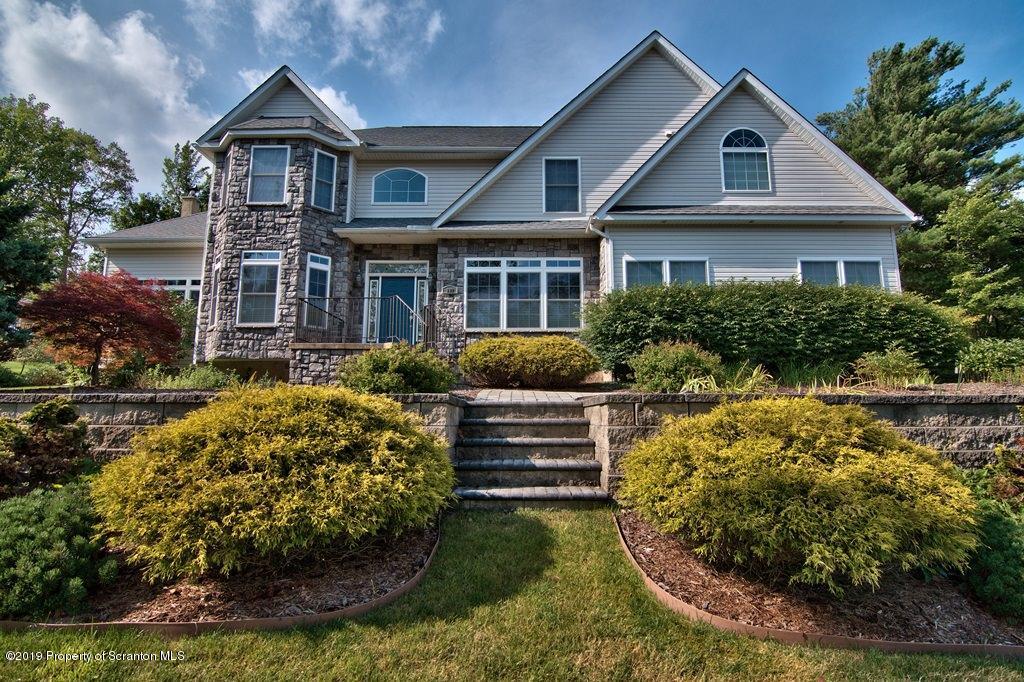 801 Forest Road Lake Ariel, PA 18436 - Photo 1 of 54 a front view of a house with a yard