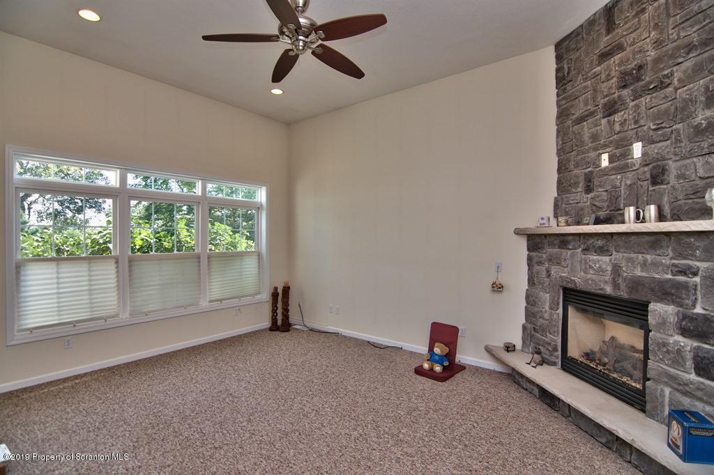 801 Forest Road Lake Ariel, PA 18436 - Photo 16 of 54 a view of an empty room with a fireplace and window