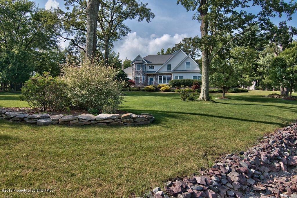 801 Forest Road Lake Ariel, PA 18436 - Photo 2 of 54 a view of a house with a garden and sitting area
