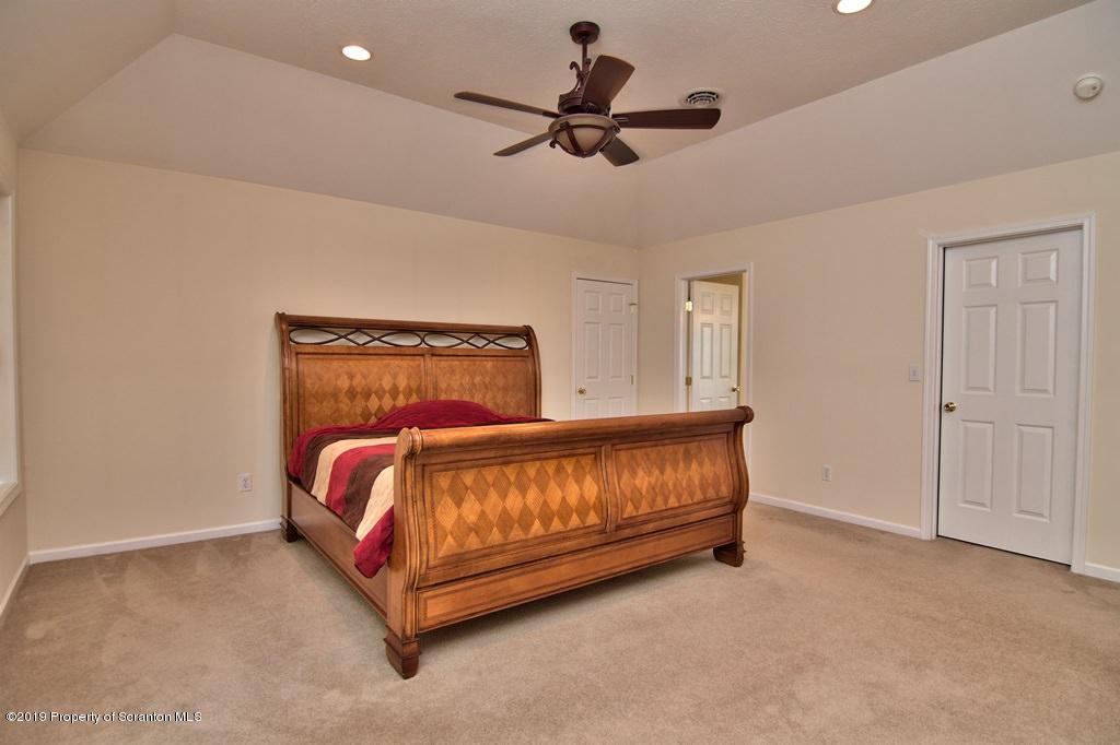801 Forest Road Lake Ariel, PA 18436 - Photo 24 of 54 a bedroom with a bed and a ceiling fan