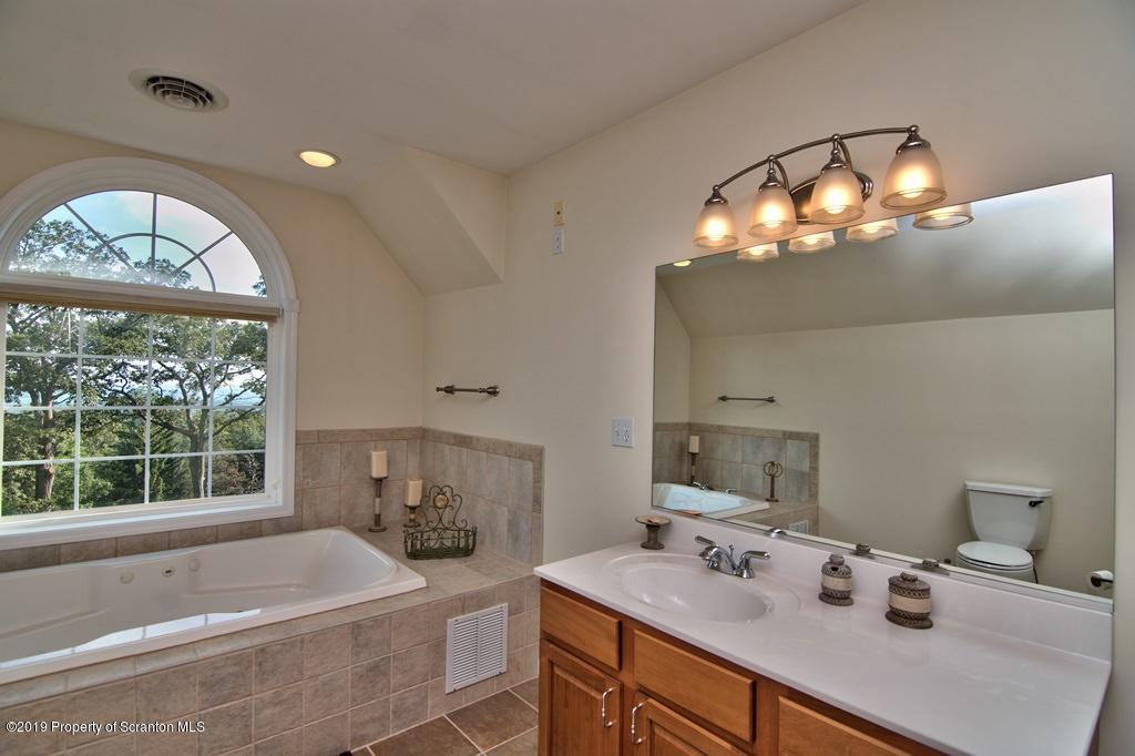 801 Forest Road Lake Ariel, PA 18436 - Photo 25 of 54 a bathroom with a tub sink and mirror