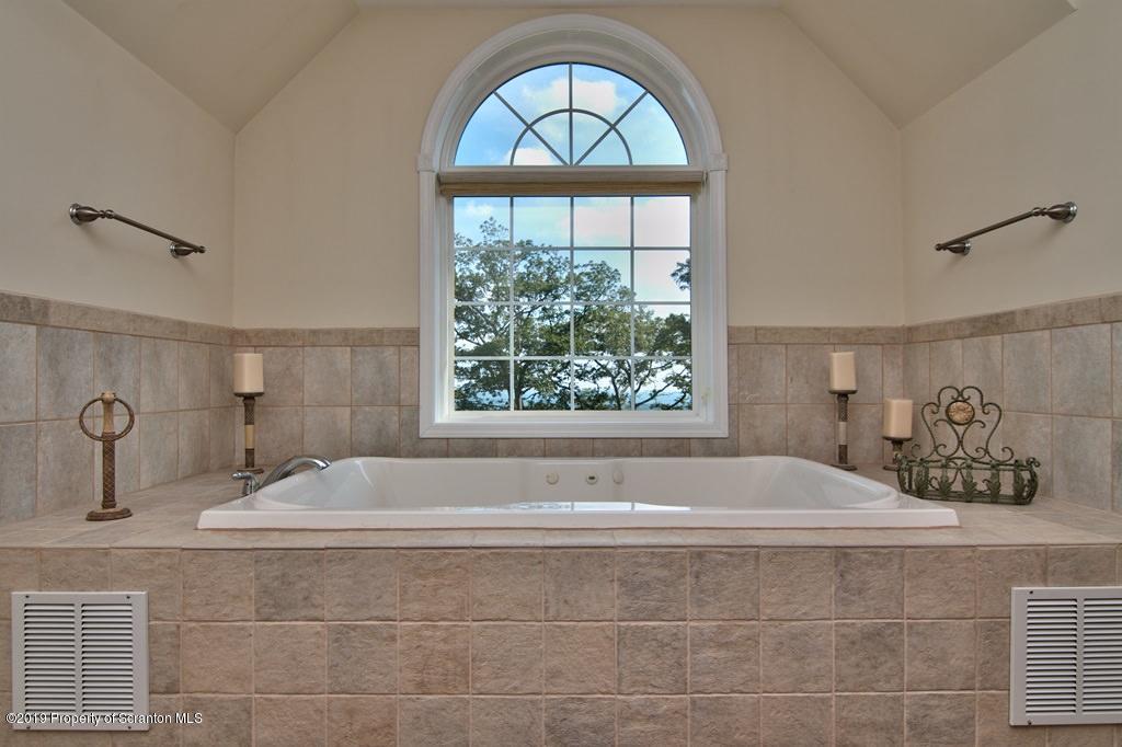 801 Forest Road Lake Ariel, PA 18436 - Photo 26 of 54 a bathroom with a tub a sink and a window