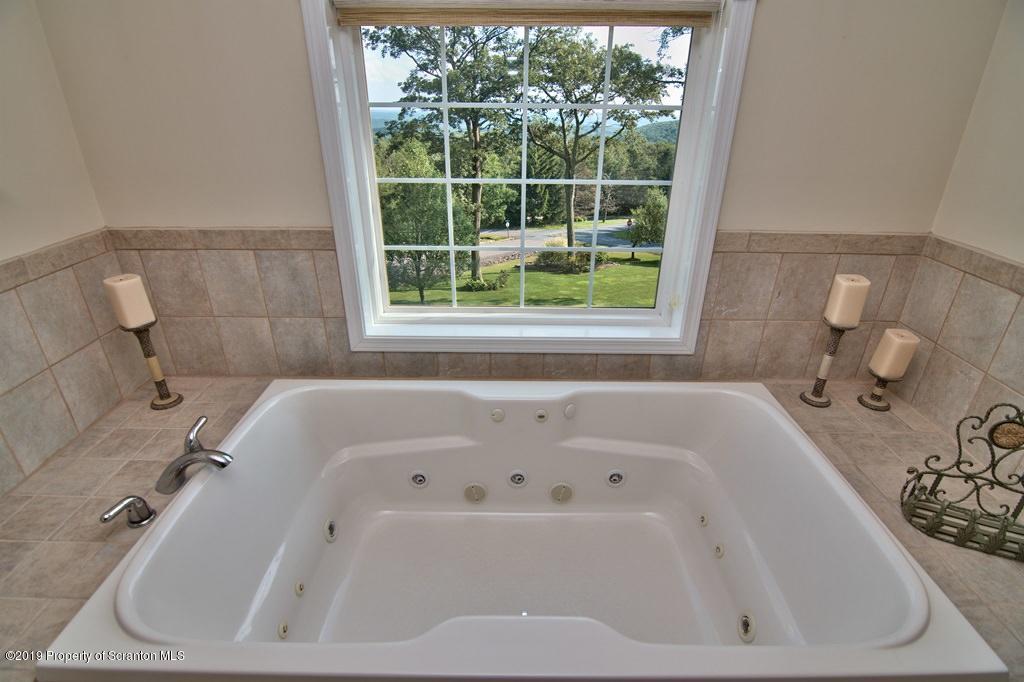 801 Forest Road Lake Ariel, PA 18436 - Photo 27 of 54 a white bath tub sitting in a bathroom next to a window