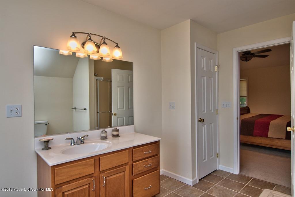 801 Forest Road Lake Ariel, PA 18436 - Photo 29 of 54 a bathroom with a sink and a mirror
