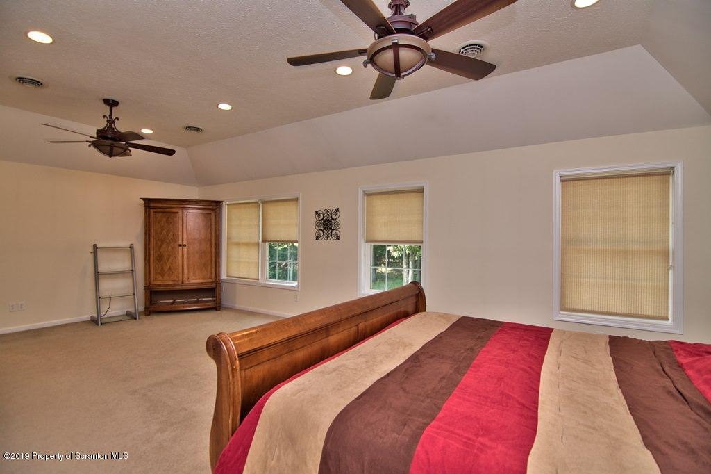 801 Forest Road Lake Ariel, PA 18436 - Photo 30 of 54 a bedroom with a large bed and a window
