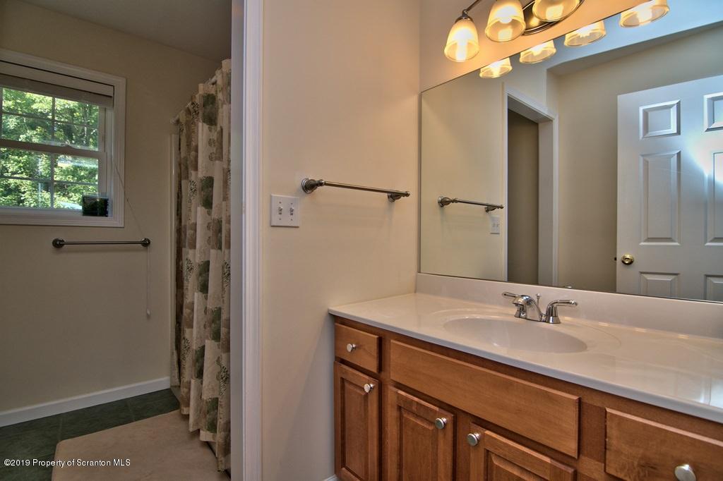 801 Forest Road Lake Ariel, PA 18436 - Photo 37 of 54 a bathroom with a sink vanity granite and a mirror