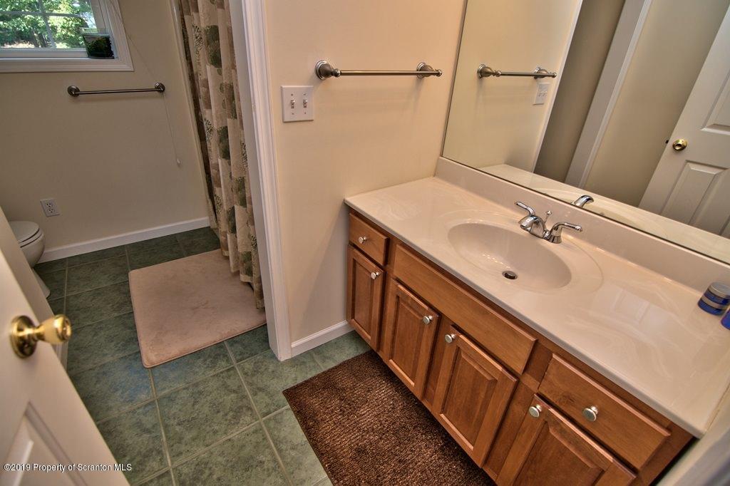 801 Forest Road Lake Ariel, PA 18436 - Photo 38 of 54 a bathroom with a sink a mirror and shower
