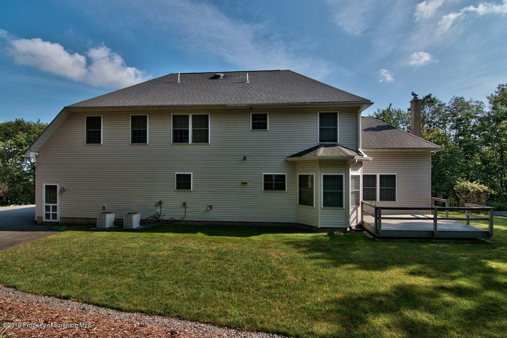 801 Forest Road Lake Ariel, PA 18436 - Photo 50 of 54 a front view of a house with a garden