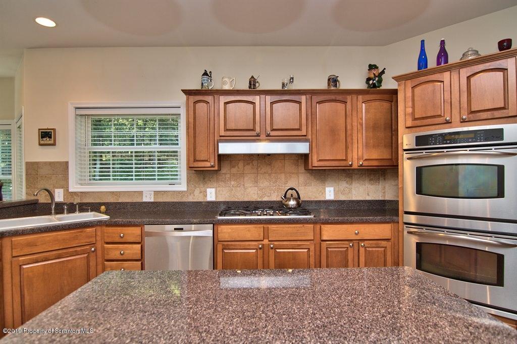 801 Forest Road Lake Ariel, PA 18436 - Photo 9 of 54 a kitchen with stainless steel appliances granite countertop a stove sink and cabinets