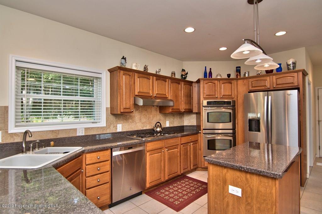 801 Forest Road Lake Ariel, PA 18436 - Photo 10 of 54 a kitchen with stainless steel appliances granite countertop a sink a stove and a refrigerator
