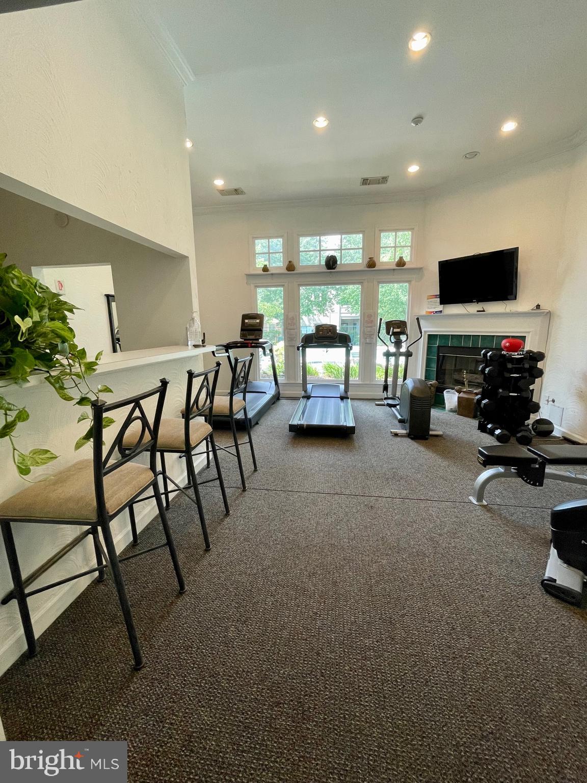 12009 Taliesin Place, Unit 31 Reston, VA 20190 - Photo 17 of 19 a living room with furniture and a flat screen tv