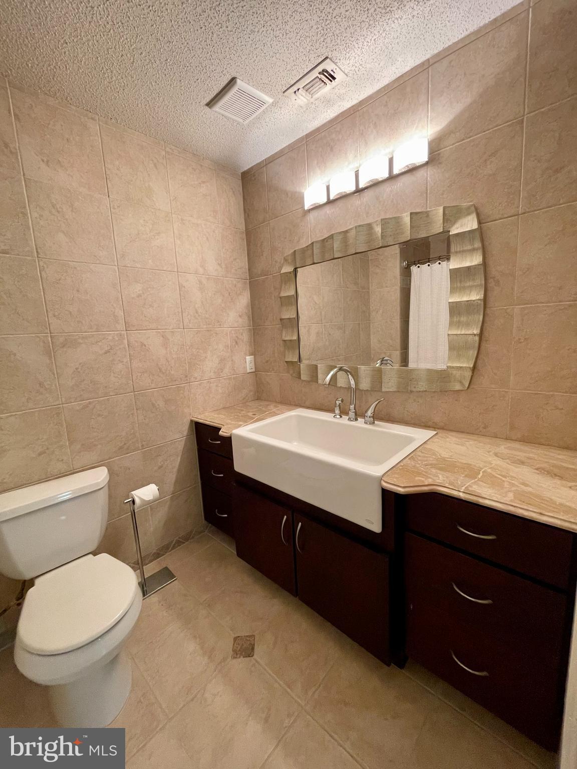 12009 Taliesin Place, Unit 31 Reston, VA 20190 - Photo 5 of 19 a bathroom with a sink toilet and mirror