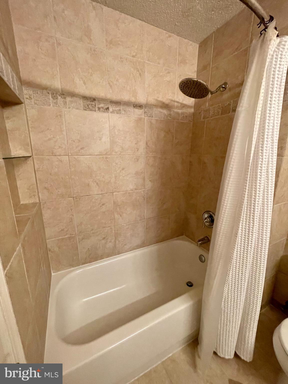 12009 Taliesin Place, Unit 31 Reston, VA 20190 - Photo 6 of 19 a bathroom with a bathtub and a shower