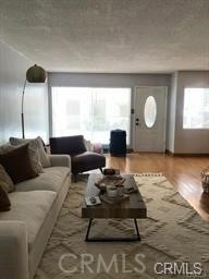 1139 East Ocean Boulevard, Unit 109 Long Beach, CA 90802 - Photo 11 of 14 a living room with furniture and a large window