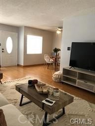 1139 East Ocean Boulevard, Unit 109 Long Beach, CA 90802 - Photo 9 of 14 a living room with furniture and a flat screen tv