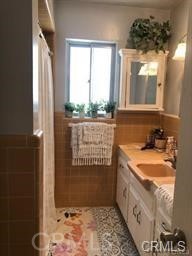 1139 East Ocean Boulevard, Unit 109 Long Beach, CA 90802 - Photo 10 of 14 a bathroom with a tub a sink and a shower