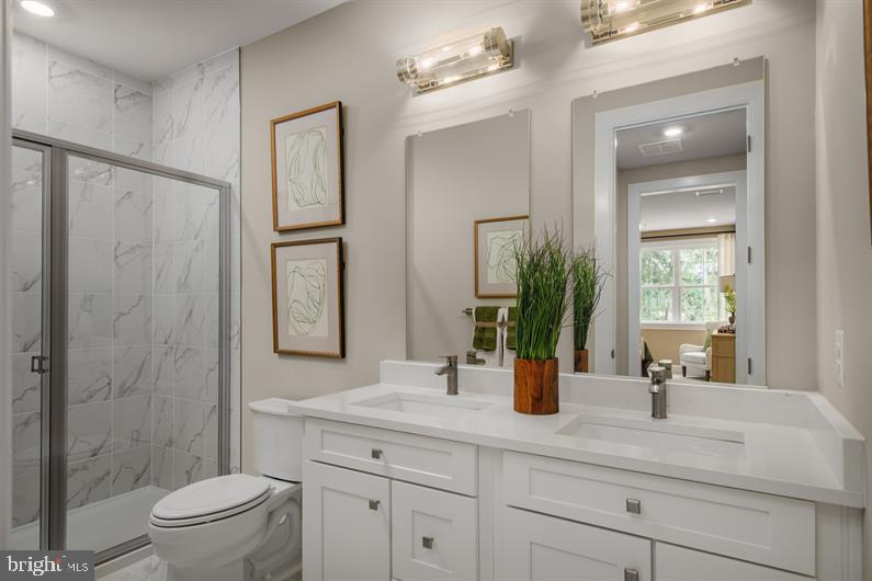 9434 Founders Lane Perry Hall, MD 21128 - Photo 15 of 18 a bathroom with a double vanity sink toilet and shower