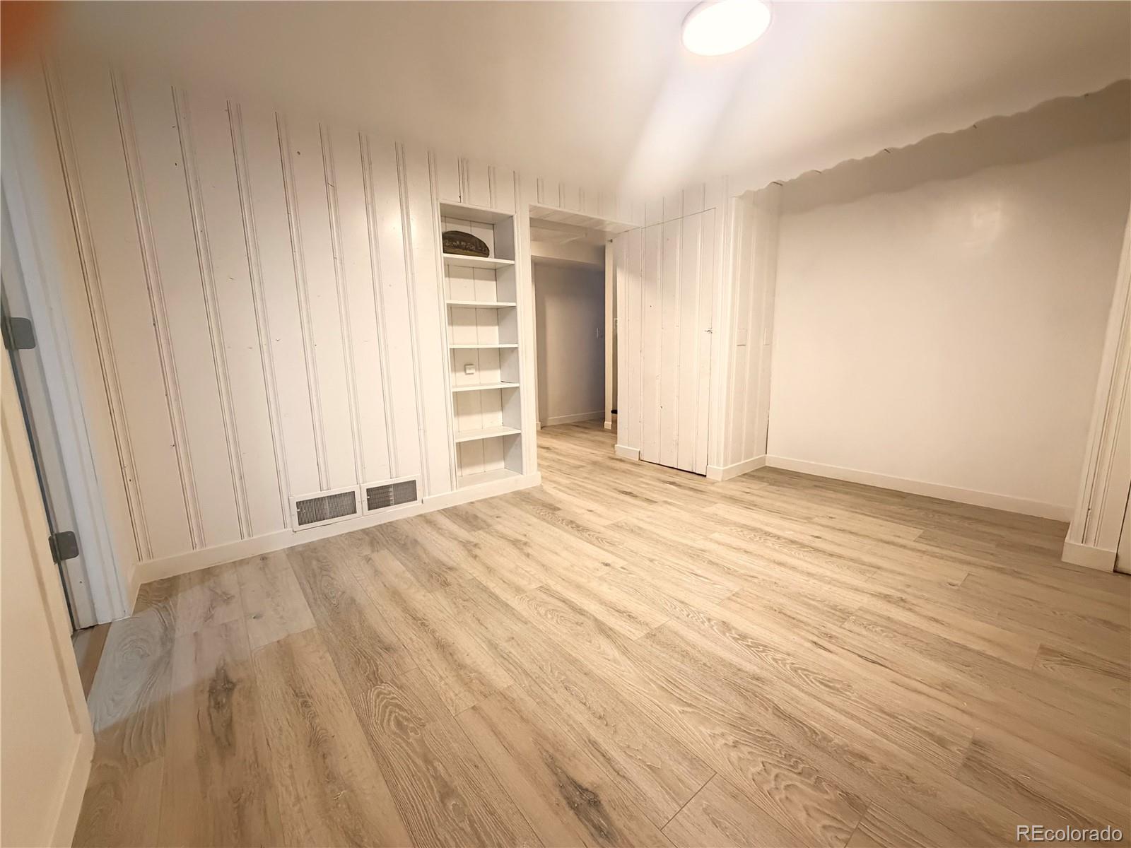 1173 Ironton Street Aurora, CO 80010 - Photo 20 of 28 an empty room with wooden floor and closet