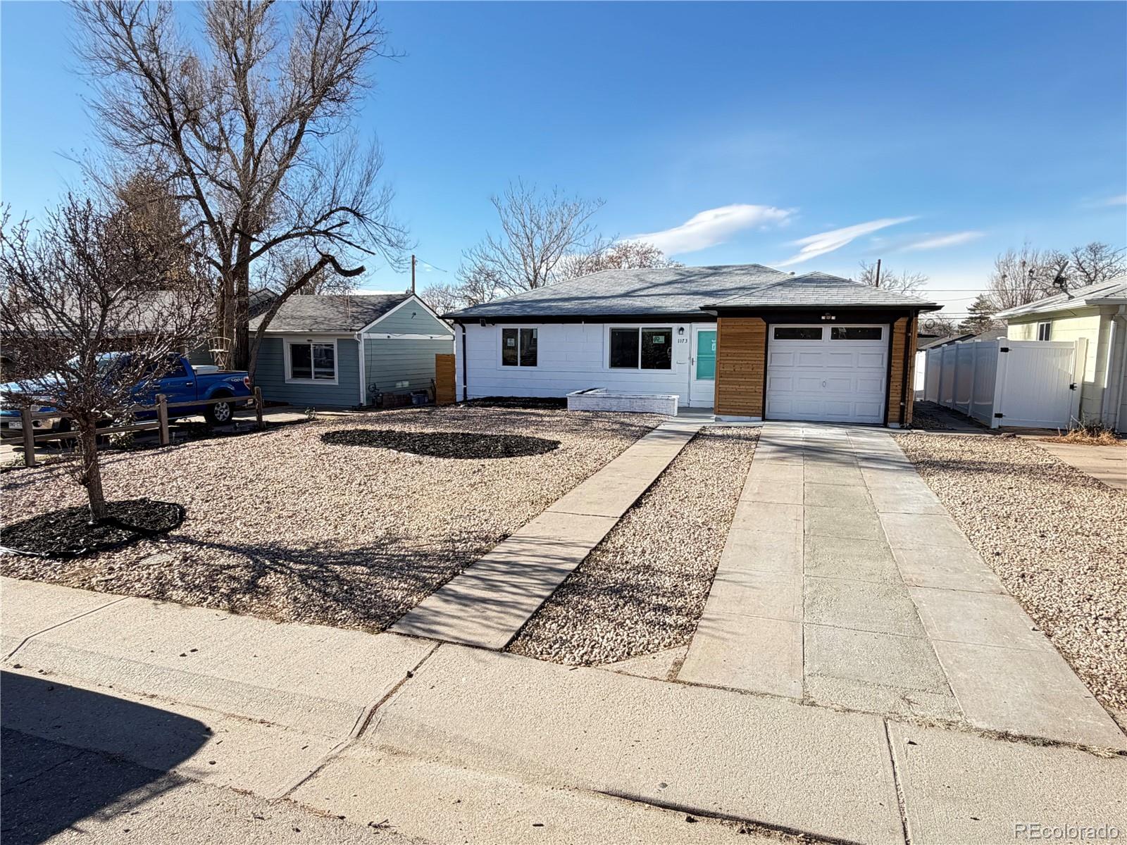 1173 Ironton Street Aurora, CO 80010 - Photo 3 of 28 a front view of a house with yard