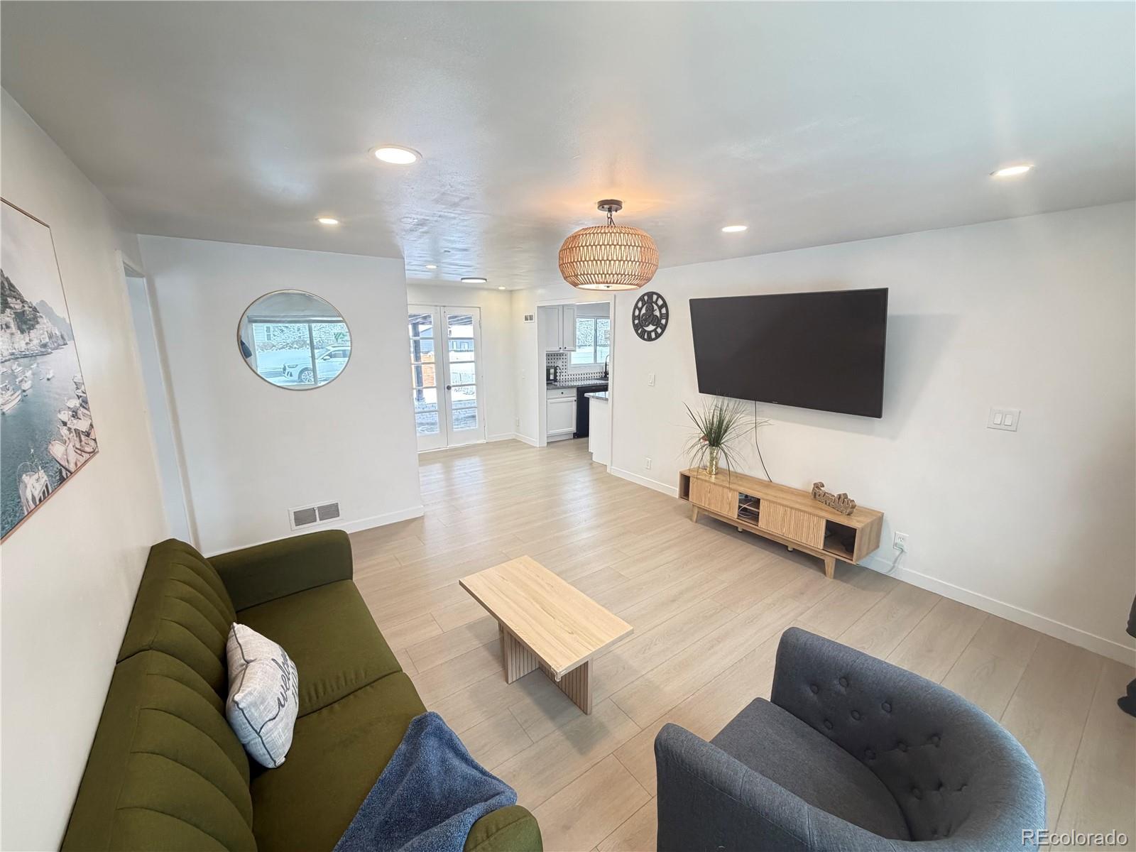 1173 Ironton Street Aurora, CO 80010 - Photo 7 of 28 a living room with furniture and a flat screen tv