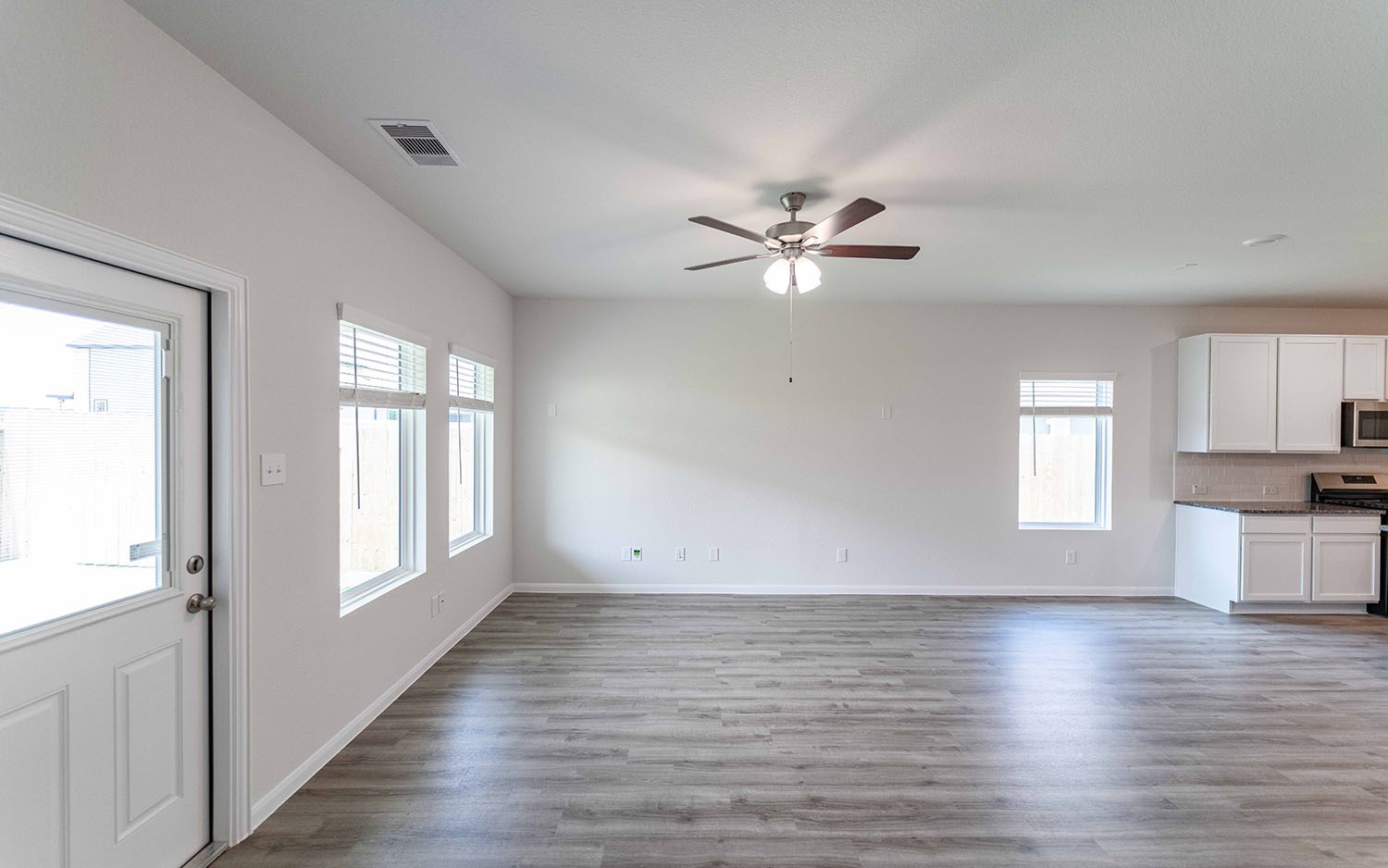 4326 Maple Root Lane Pinehurst, TX 77362 - Photo 13 of 27 an empty room with wooden floor and window