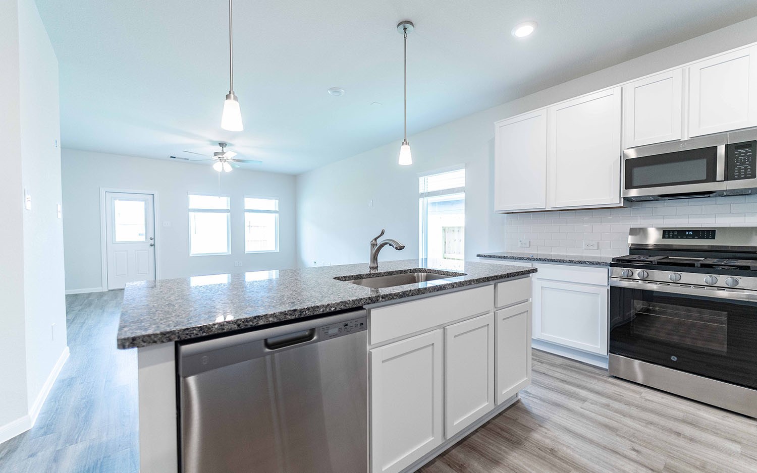 4326 Maple Root Lane Pinehurst, TX 77362 - Photo 9 of 27 a kitchen with granite countertop a sink cabinets and stainless steel appliances