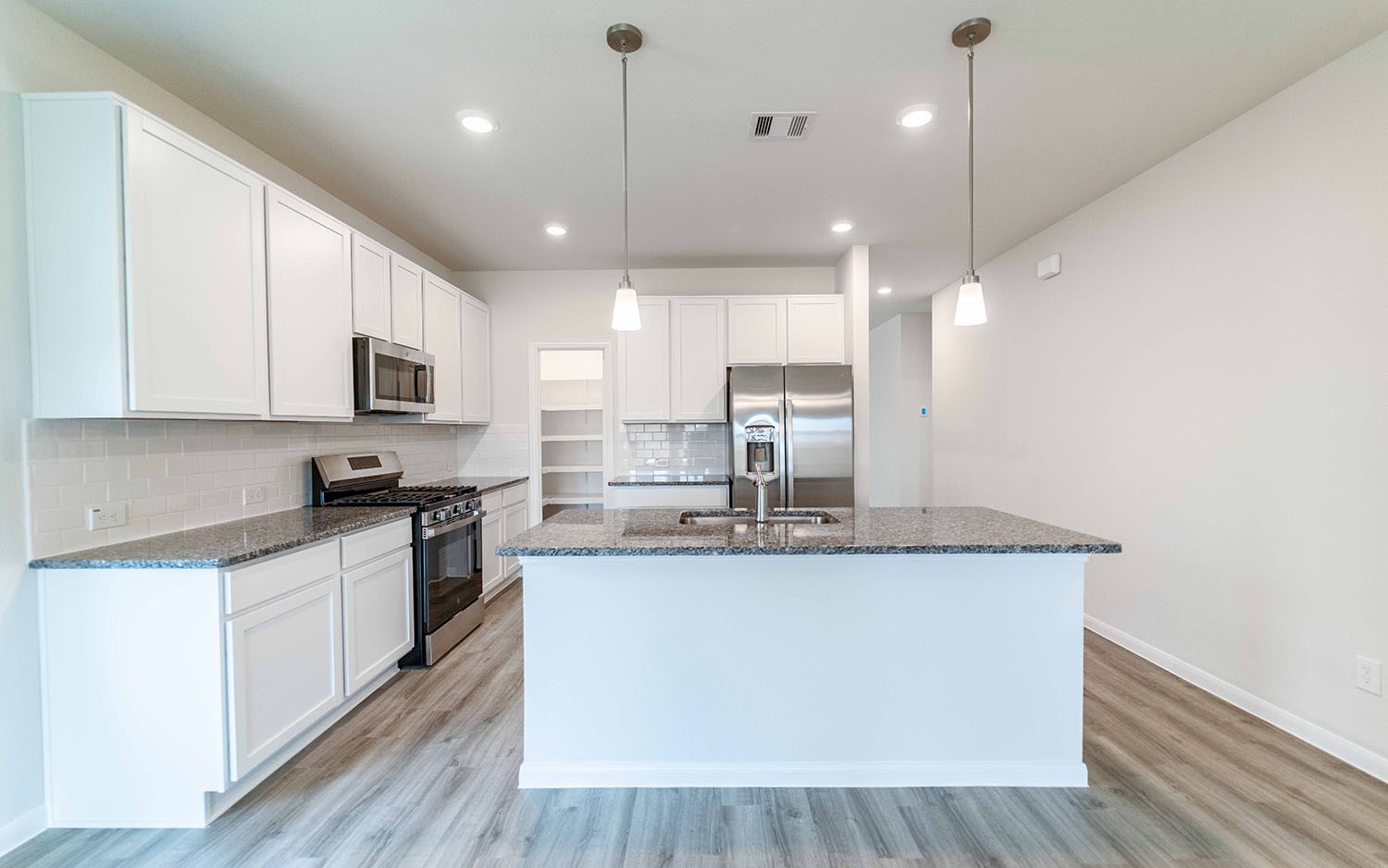 4326 Maple Root Lane Pinehurst, TX 77362 - Photo 10 of 27 a kitchen with stainless steel appliances granite countertop a sink a stove top oven a counter space and cabinets