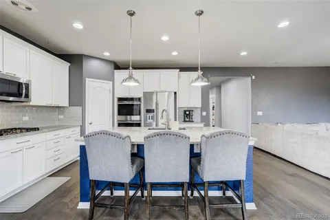 a kitchen with a center island and stainless steel appliances