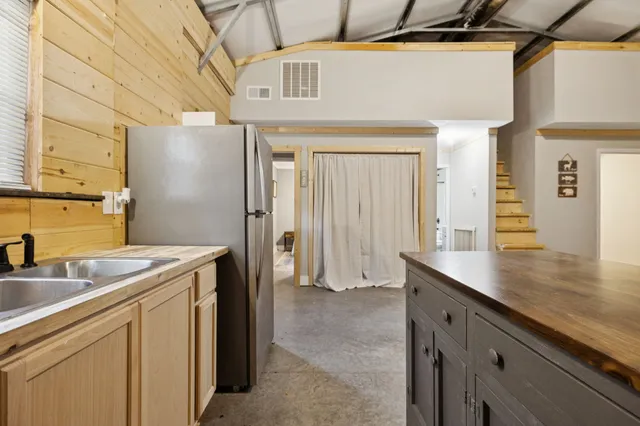 a utility room with a sink a refrigerator and washer