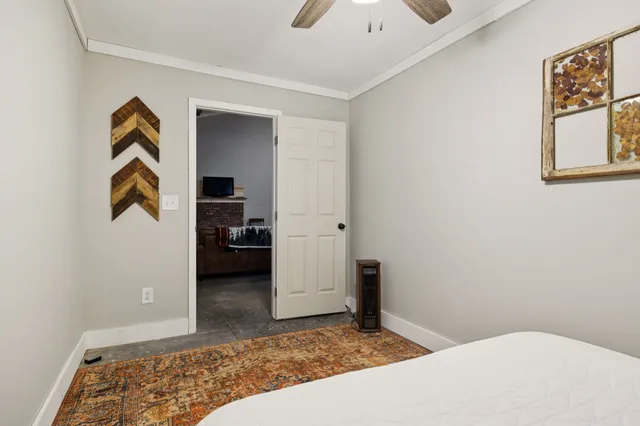 a bedroom with a bed and a view of bathroom