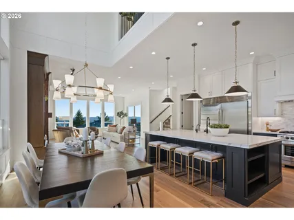 a kitchen with a table chairs stove and cabinets