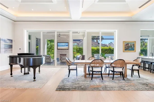 a living room with furniture large windows and a table