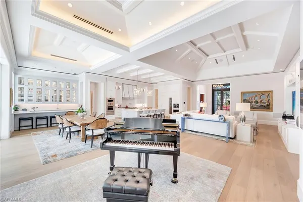 a living room with furniture a rug and kitchen view