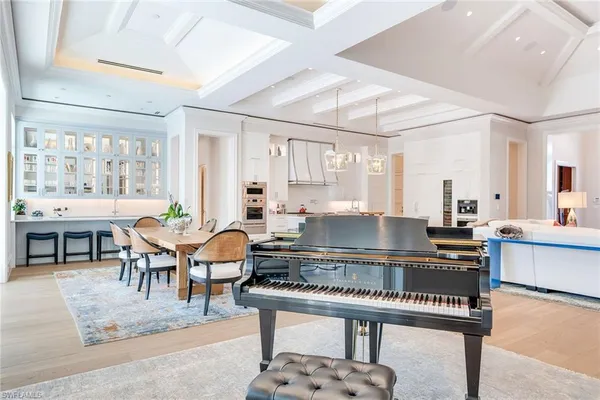 a kitchen with a dining table chairs and stove