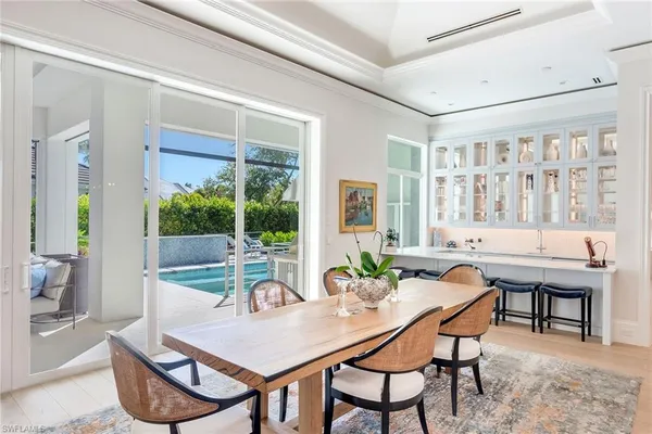 a view of a dining room with furniture large windows and wooden floor