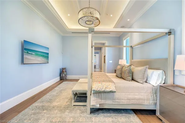 a bedroom with a bed mirror and a window