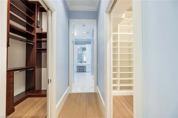 a view of walk in closet with empty racks