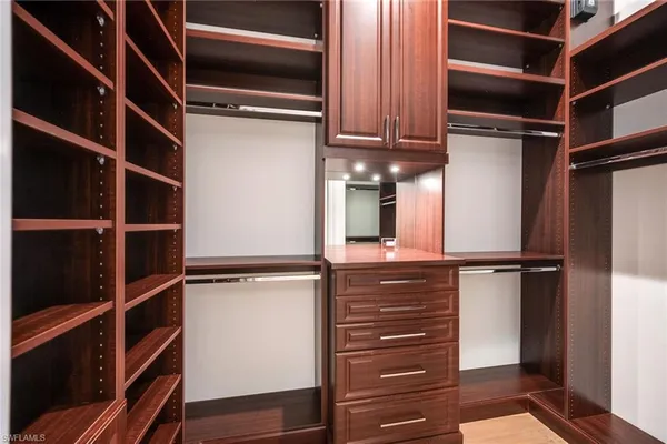 a view of walk in closet with empty racks