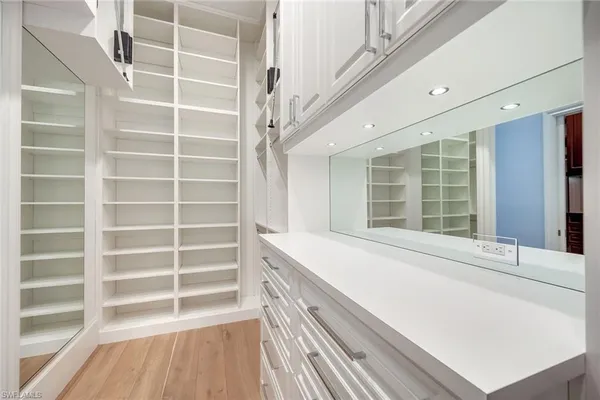 a view of a walk in closet with empty racks