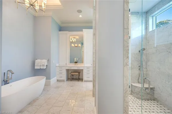 a spacious bathroom with a tub shower and sink