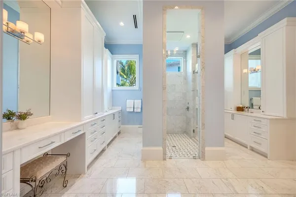 a bathroom with a granite countertop sink a toilet a mirror and shower