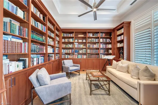 a work room with furniture and a book shelf