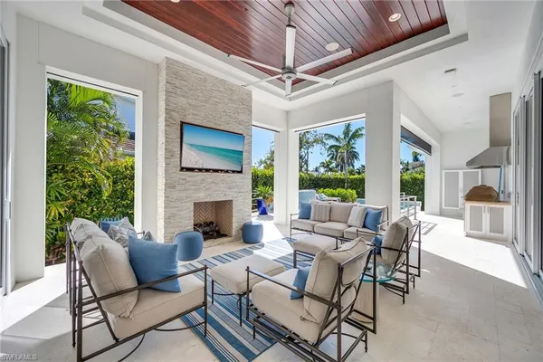 a living room with furniture fireplace and a large window