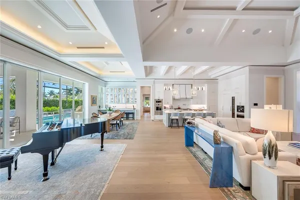 a living room with lots of furniture and a large window