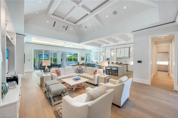 a living room with lots of furniture and a large window