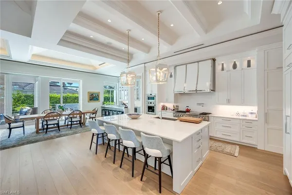 a kitchen with a table chairs stove and cabinets