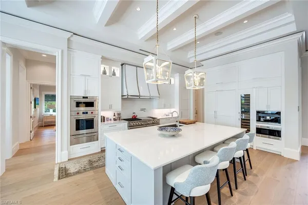 a kitchen with a table chairs microwave and cabinets