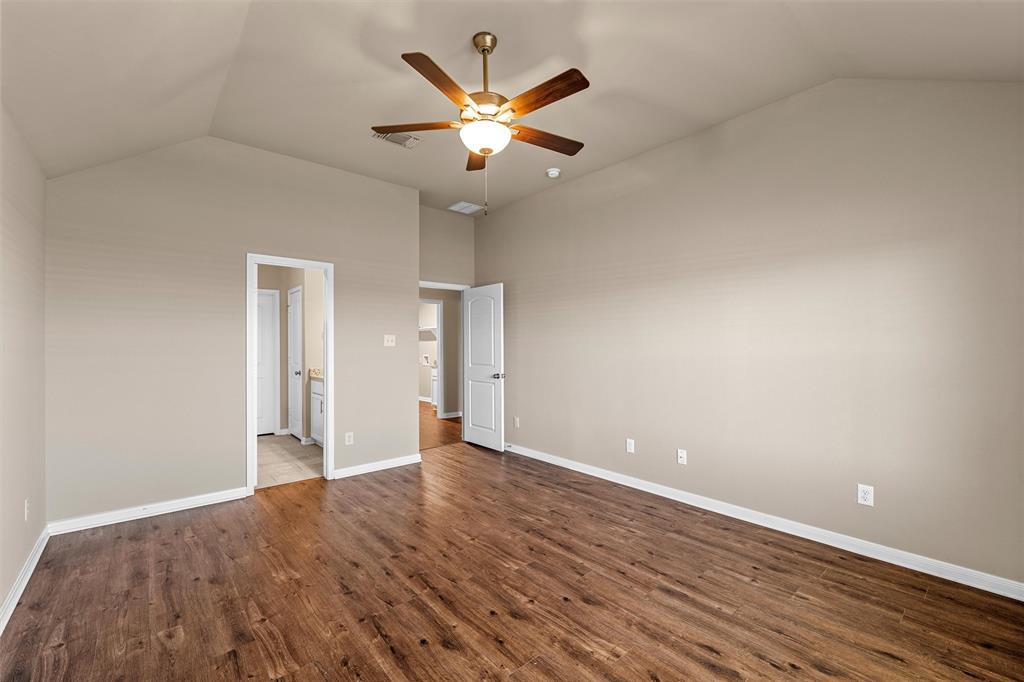 313 Branch Road Woodway, TX 76712 - Photo 11 of 16 an empty room with wooden floor and ceiling fan