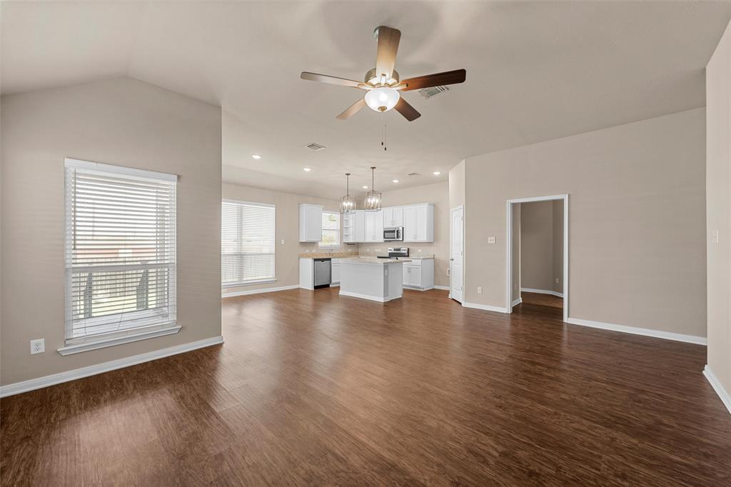 313 Branch Road Woodway, TX 76712 - Photo 2 of 16 a view of an empty room with a kitchen and wooden floor
